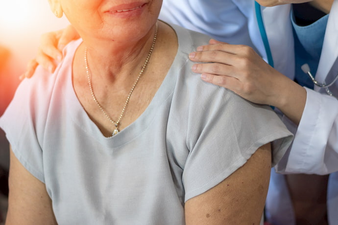 doctor comforting an older patient