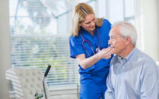 medical professional assists man with oxygen cannula