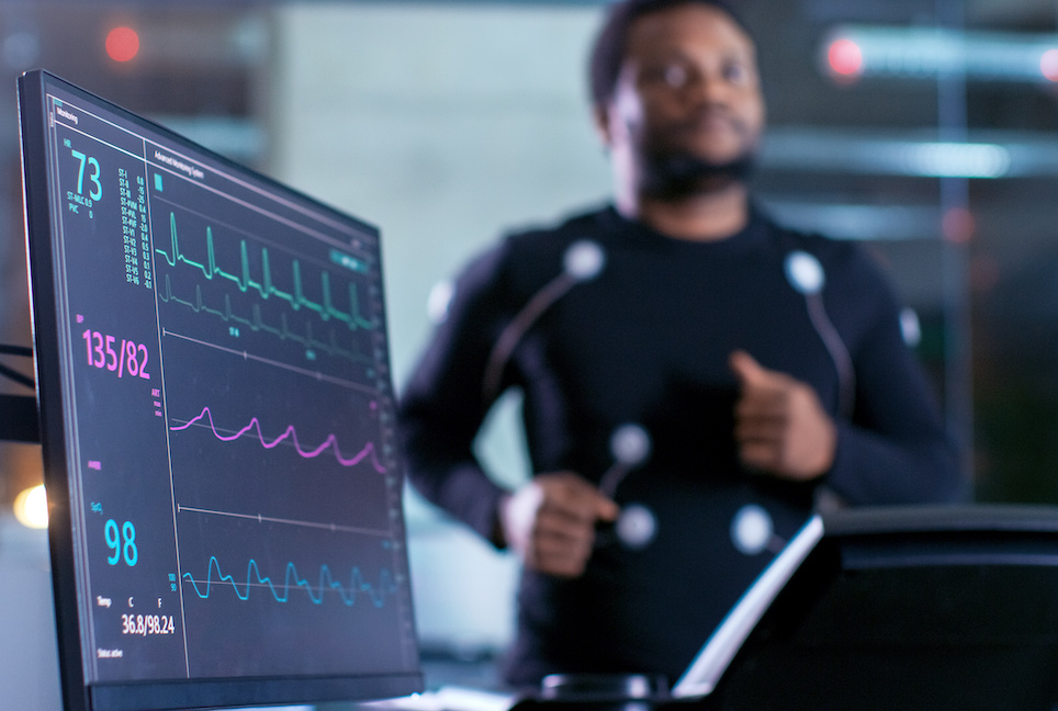 Runner shown behind computer screen with heart rate shown.