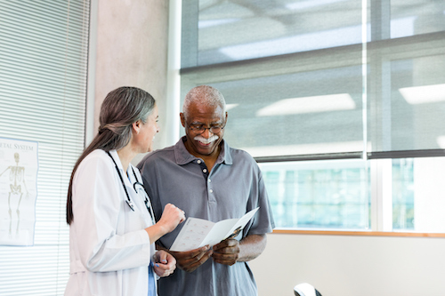 Physician talking with man about his results.