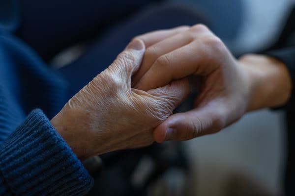 Hands being held by one another.