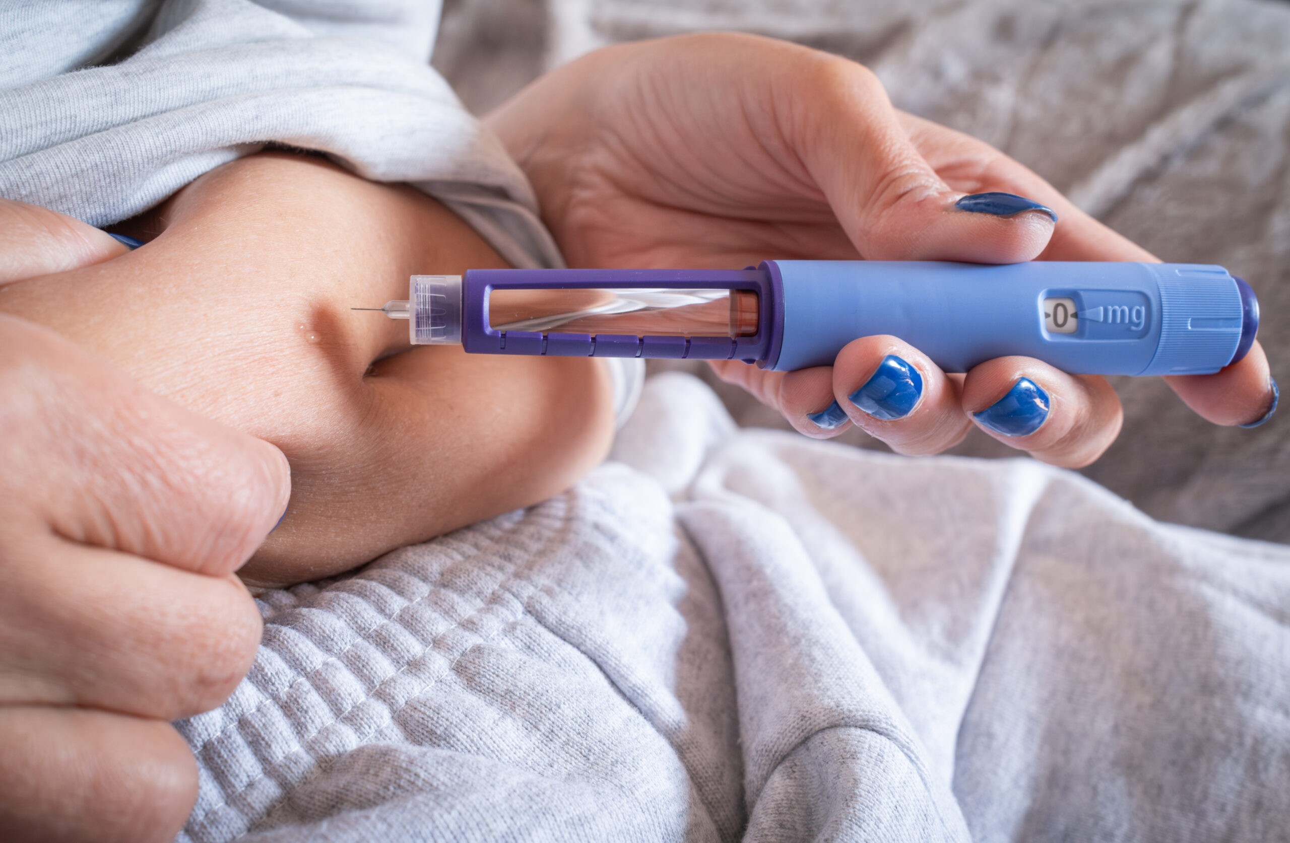 Woman giving herself a GLP-1 injection