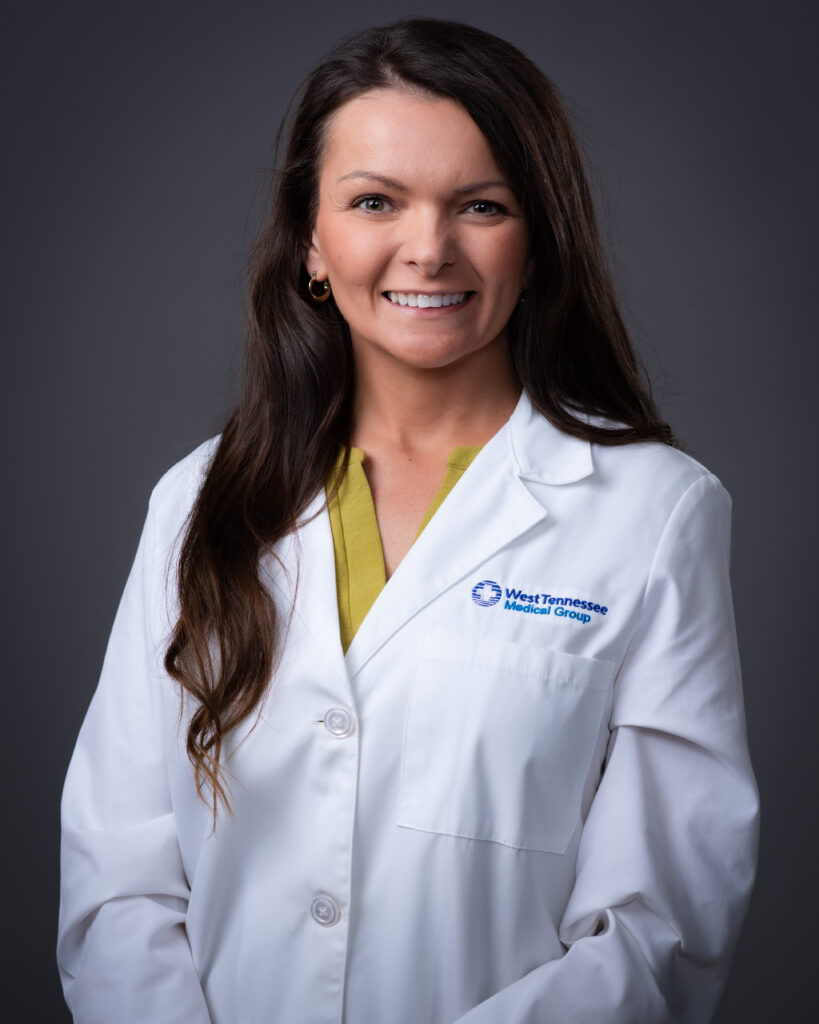 Britany Proudfit, urology provider at West Tennessee Medical Group, wearing a white coat in professional headshot