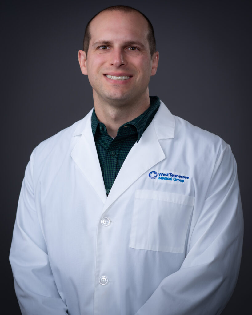 Hunter Newsome, FNP wearing a white coat with West Tennessee Medical Group logo, professional headshot in Jackson, Tennessee